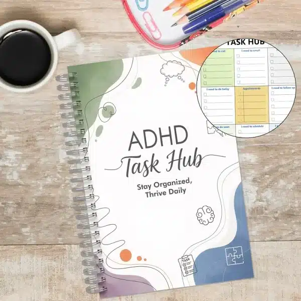 ADHD Task Hub daily planner on a wooden desk with a coffee cup, showing the calming abstract cover design.