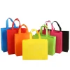 A lineup of colorful reusable non-woven shopping bags in black, green, blue, pink, red, and orange.