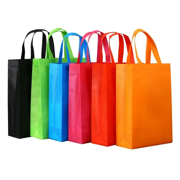 A lineup of colorful reusable non-woven shopping bags in black, green, blue, pink, red, and orange.