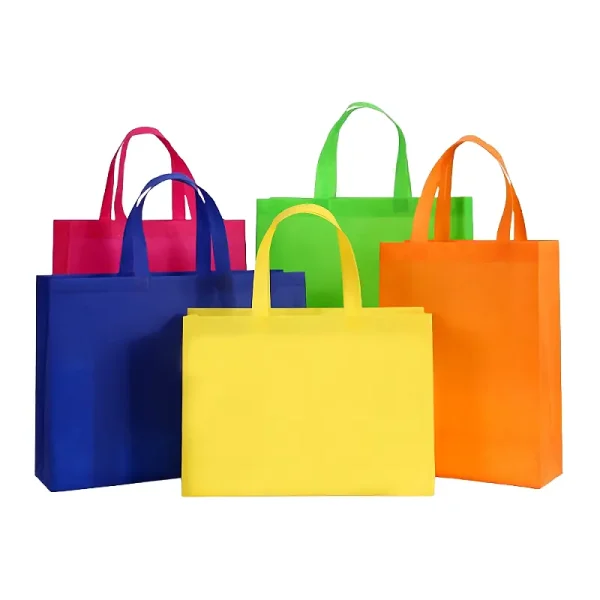 An assortment of vibrant non-woven promotional bags in yellow, blue, pink, green, and orange on a white background.