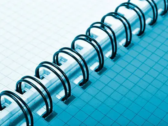 Close-up of a custom spiral notebook with Wire-O binding showing the lay-flat design.
